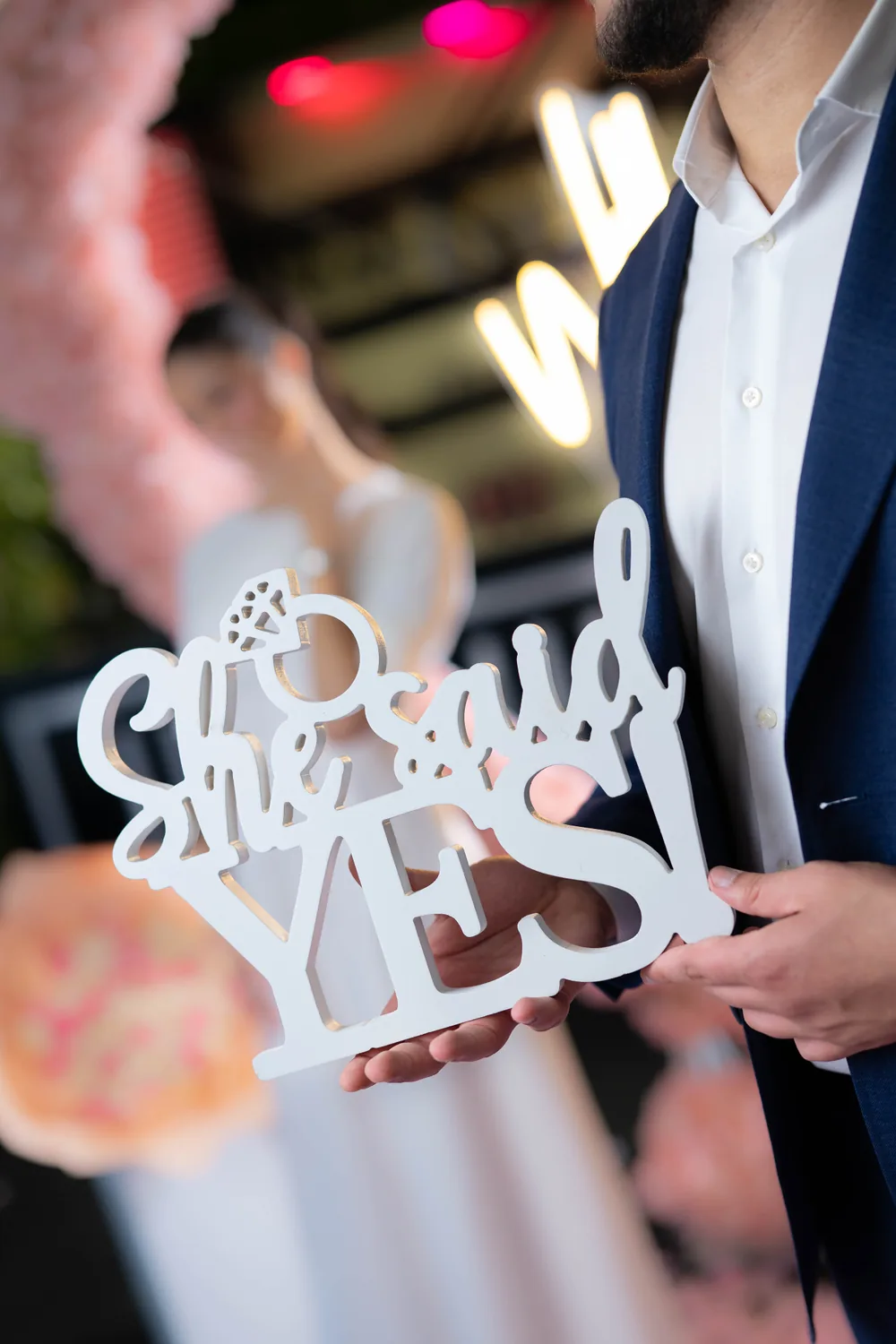 A man holding up a She Said Yes sign