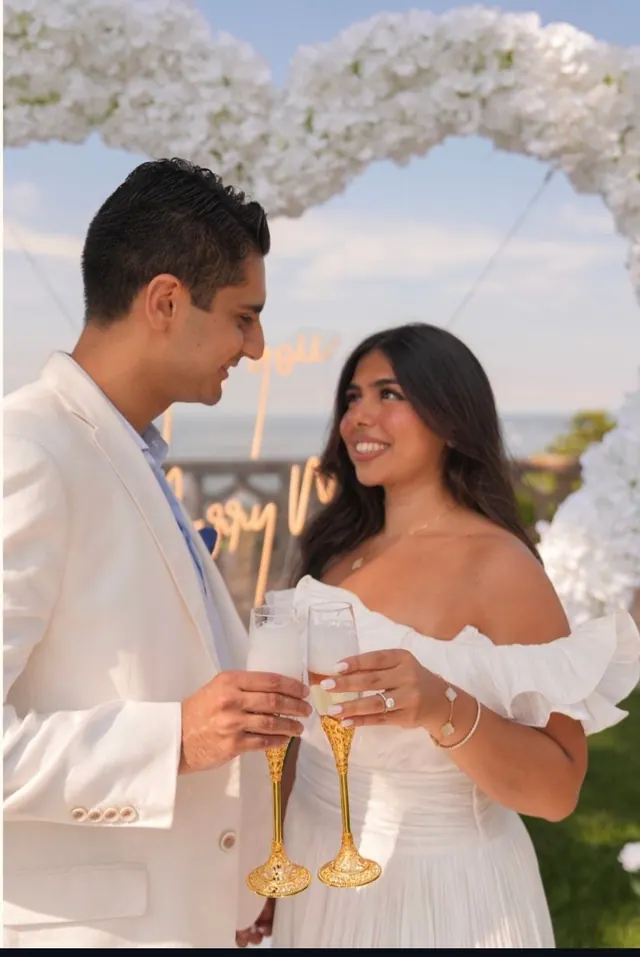 A champagne toast, her ring on show