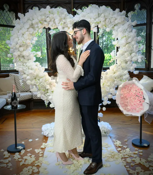 An embrace inside a white rose heart